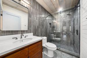 a bathroom with a toilet and a shower and a sink at Peach and Plumeria Hideaway in Cherry Log +23 photos