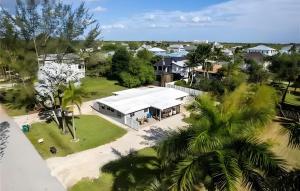 an aerial view of a house with a white roof at Charming 1BR Canal Front Retreat in Naples