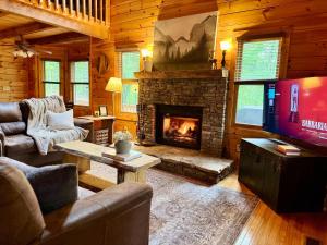 a living room with a fireplace and a tv at The Tree House- Wifi- Firepit- 2 Fireplaces-Garden Tub-Free Activities in Morganton