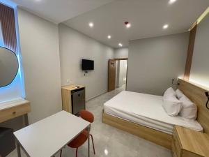a bedroom with a bed and a table and a tv at Cairo Galaxy Hostel in Cairo