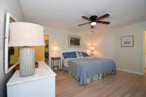 a bedroom with a bed and a ceiling fan at Spacious 4-Bed, 4-Bath Home in the heart of Fripp Island in Fripp Island