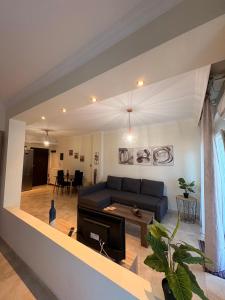 a living room with a couch and a table at ROTONDA SKG in Thessaloniki +25 photos