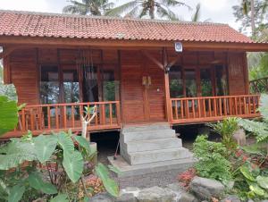 a wooden house with steps leading to it at Loka Amertha in Sidemen