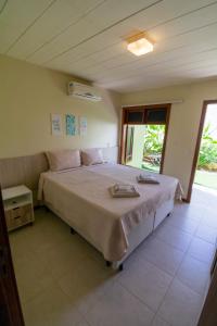Katil atau katil-katil dalam bilik di A Casita Imbassai, localização estratégica em um espaço com encanto