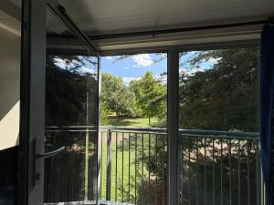 an open door to a balcony with a view at Cosy 2-Bed Flat Near ExCeL and City Airport in London