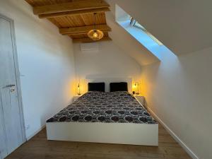 a bedroom with a large bed in a attic at Wonder Lelle - Balaton Retreat in Balatonlelle