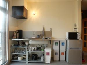 a small kitchen with a counter and a sink at HITOYANE guesthouse-1日1組限定- in Aizuwakamatsu