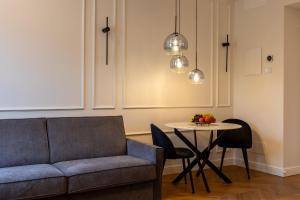 a living room with a couch and a table at Twins Boutique Apartments in Sanremo