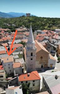 an aerial view of a town with a church at Holiday house with a parking space Senj - 24830 in Senj