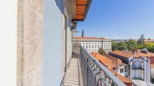 a balcony of a building with a view of a city at Carmo Apartamentos in Porto