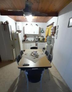 a kitchen with a table and chairs in a room at Mi Casita del Paso in Paso de la Patria +7 photos