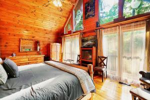 a bedroom with a bed in a wooden cabin at Wonderland Cabin in Sevierville