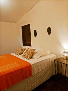 a bedroom with a bed with two pillows on it at Pousada Luar do Sertão in Lençóis +46 photos