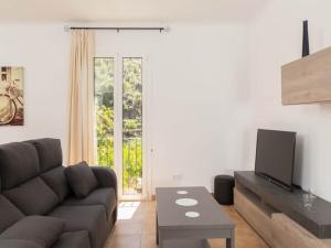 a living room with a couch and a tv at Town House Alba in Fornalutx in Fornalutx