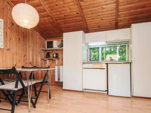 a kitchen with a table and chairs in a room at 4 person holiday home in Hampen in Hampen