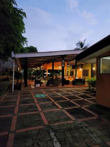 a building with a patio with tables and chairs at Atlakamani Surf in Chirilagua