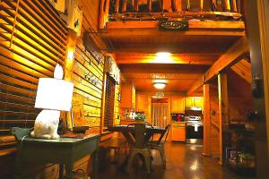 a kitchen with a table and a lamp on a table at Wonderland Cabin in Sevierville