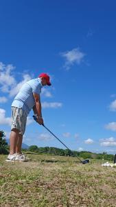 a man is playing with a kite in a field at Avodah house at Summit Point Golf and Country Club 