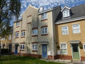 an apartment building in a neighborhood with a fence at Luton Homes in Luton