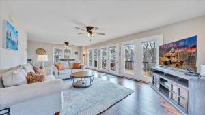 a living room with a couch and a table at Lakefront 3BR with Dock, Fire Pit, Lawn Games, and Game Room in Moneta