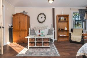 a living room with a table and a chair at Cabin close to FL Caverns! Pool, WI-FI, & Firepit in Marianna