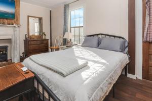 a bedroom with a large bed and a fireplace at Cabin close to FL Caverns! Pool, WI-FI, & Firepit in Marianna