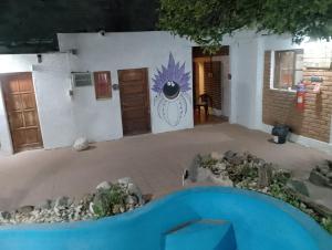 a room with a building with a painting on the wall at Posada del Valle in San Agustín de Valle Fértil