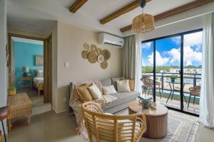 a living room with a couch and a large window at Charming 1Bdrm Apt. 10mins from Punta Cana Beaches in Punta Cana
