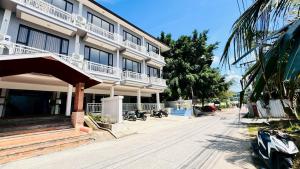 a building with balconies on the side of a street at IBay Samui Boutique Hotel in Plai Laem