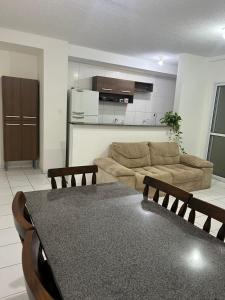 a living room with a couch and a table at Apt Luar do Sertao in Aracaju