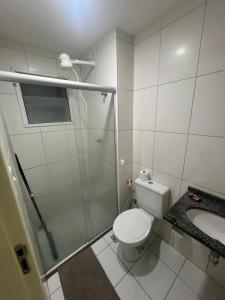 a bathroom with a shower and a toilet and a sink at Apt Luar do Sertao in Aracaju