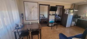 a room with a table and a room with a kitchen at Windana Cottages in Hawker
