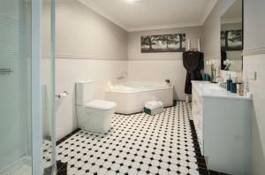 
a bathroom with a toilet, sink and bathtub at Clarendon Cottages in Sassafras
