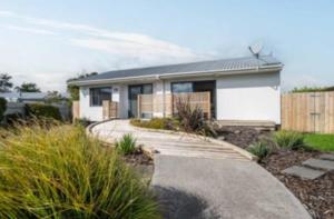 a house with a walkway in front of it at Double Room in Tauranga