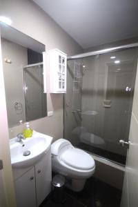 y baño con ducha, aseo y lavamanos. en Luxury Apartments Miraflores, en Lima