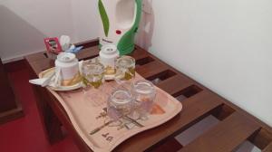 a table with a tray with glasses on it at Lakmini Guest Ella in Kumbalwela