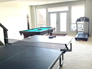 a room with two ping pong tables in a room at European-American Style Suite in Coquitlam