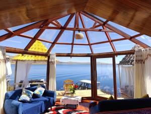 a living room with a view of the water at Luna Titicaca Grebe in Puno +5 photos
