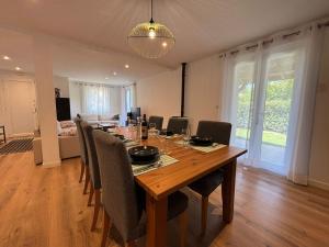 a dining room with a wooden table and chairs at Belle maison 10 pers, piscine et jardin à Urrugne - FR-1-239-1146 in Urrugne