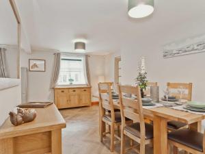 a kitchen and dining room with a table and chairs at The Barn in Carnforth