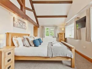 a bedroom with a large bed and a television at The Barn in Carnforth +15 photos
