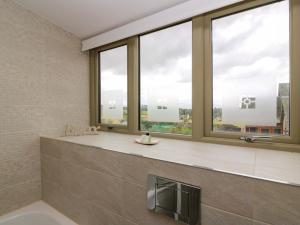 a bathroom with large windows with a view of the city at Muirmailing Cottage in Plean +28 photos