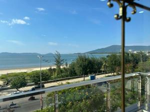 a view of a beach and the ocean from a balcony at Wind Homestay & Apartment in Danang +2 photos