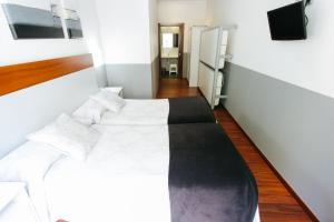 A bed or beds in a room at Hostal San Ignacio Centro