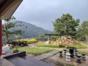 a view of a garden from a house at Homestay LubokSawah in Pekan Nanas
