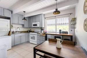 a kitchen with white cabinets and a wooden table at Chic Abode In Central Berkley in Berkeley