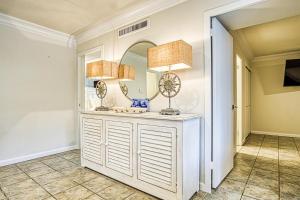 a hallway with a white dresser with a mirror at Utopia on Lake Hamilton in Hot Springs