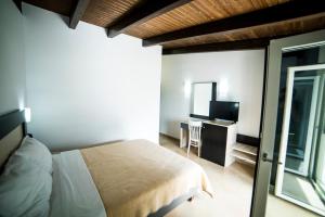 Postel nebo postele na pokoji v ubytování Hotel Dellis