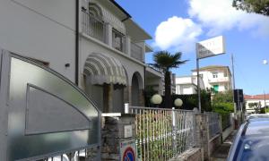 a building with a gate in front of a street at Villa Liberty Versilia in Lido di Camaiore