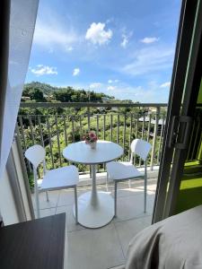 a white table and chairs on a balcony with a view at Le Menda Residences - Majestic Heights in Cebu City +43 photos